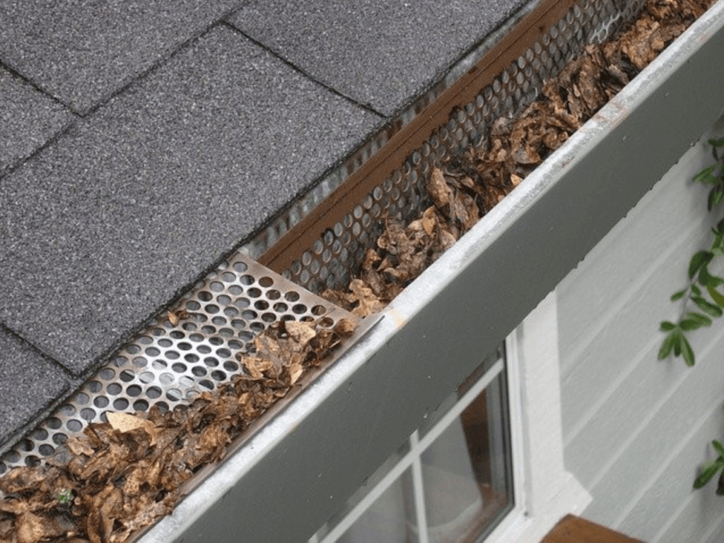 This Is What Happens If You Don't Clean Out Your Gutters - Gutters with many leaves