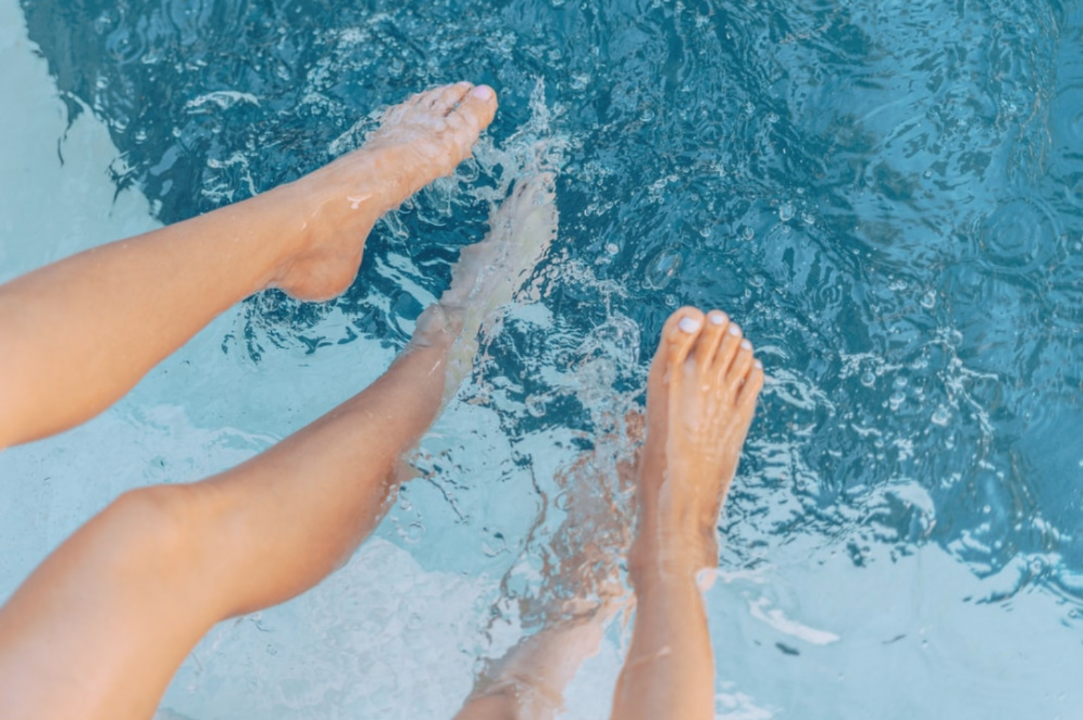 Is a Swimming Pool Worth the Money? - Feet on on swimming pool water